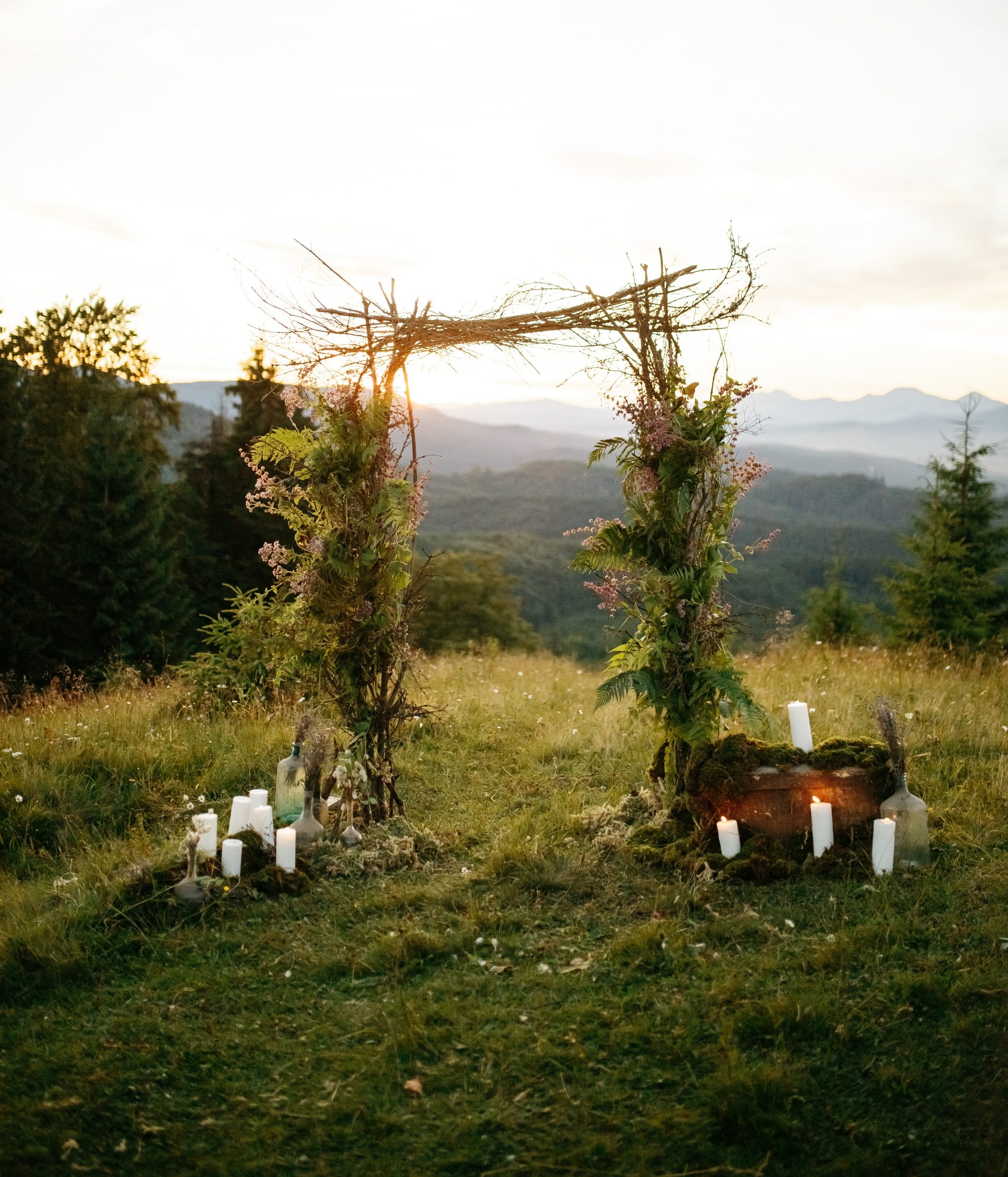 Wedding altar made of green branches and wooden sticks